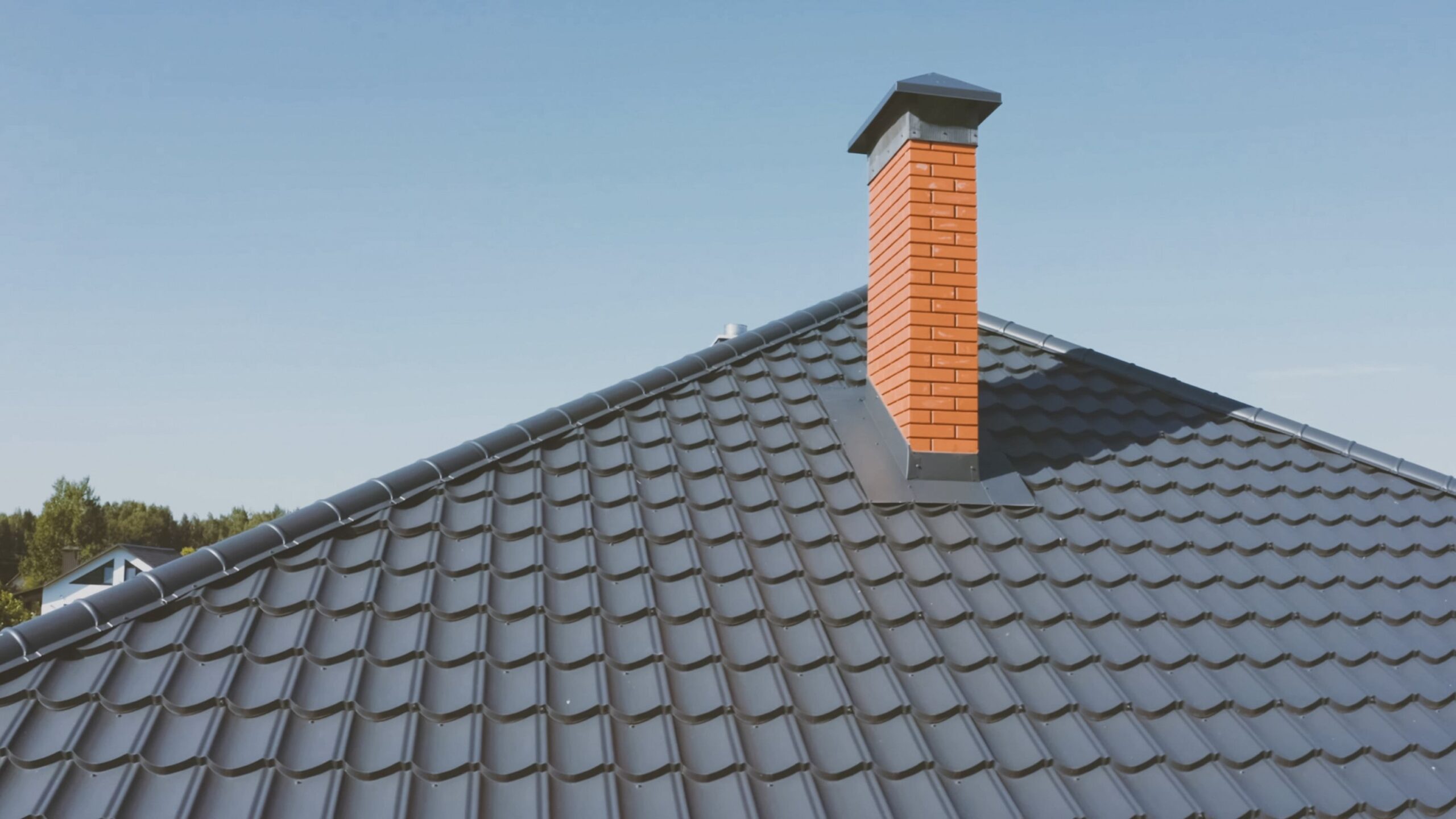 Gray metal roof with brick chimney